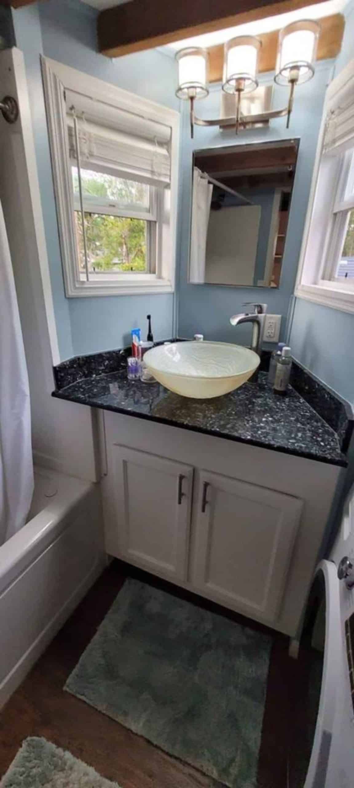 marble sink with vanity and mirror in bathroom