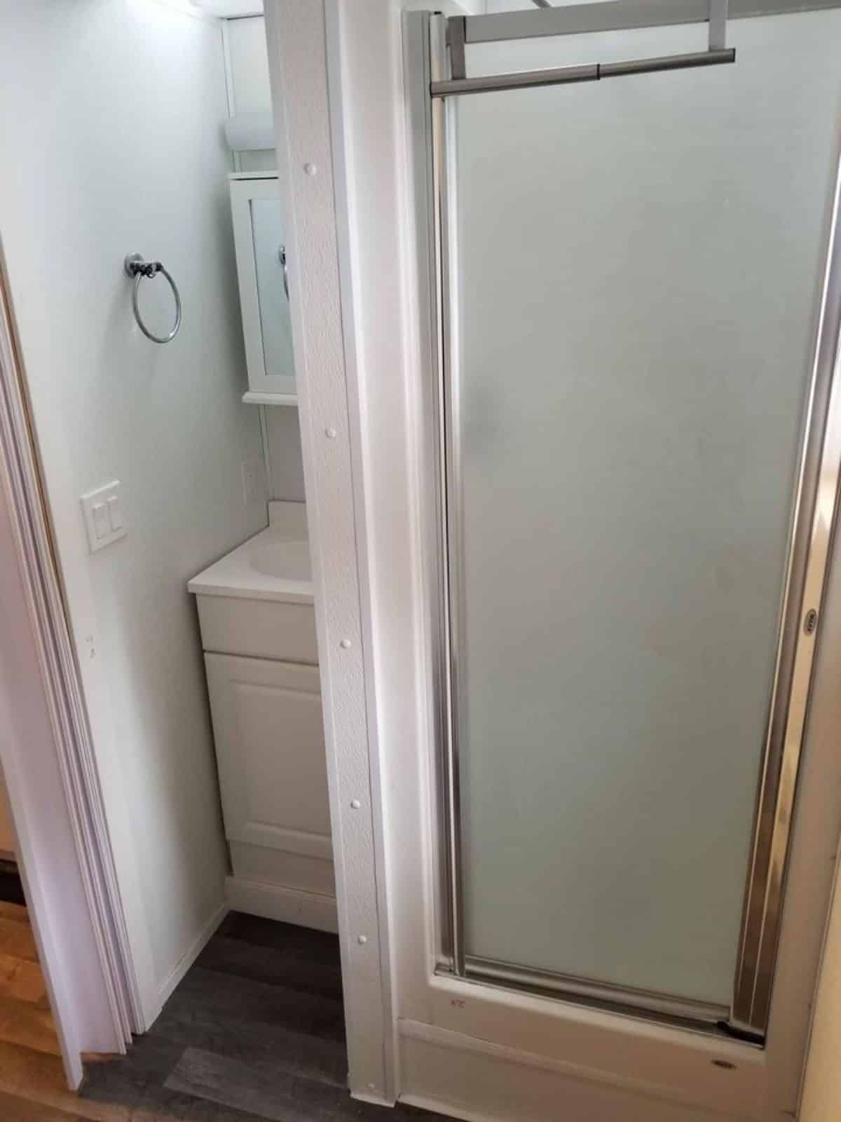 sink with vanity and mirror plus separate shower area with glass enclosure in bathroom