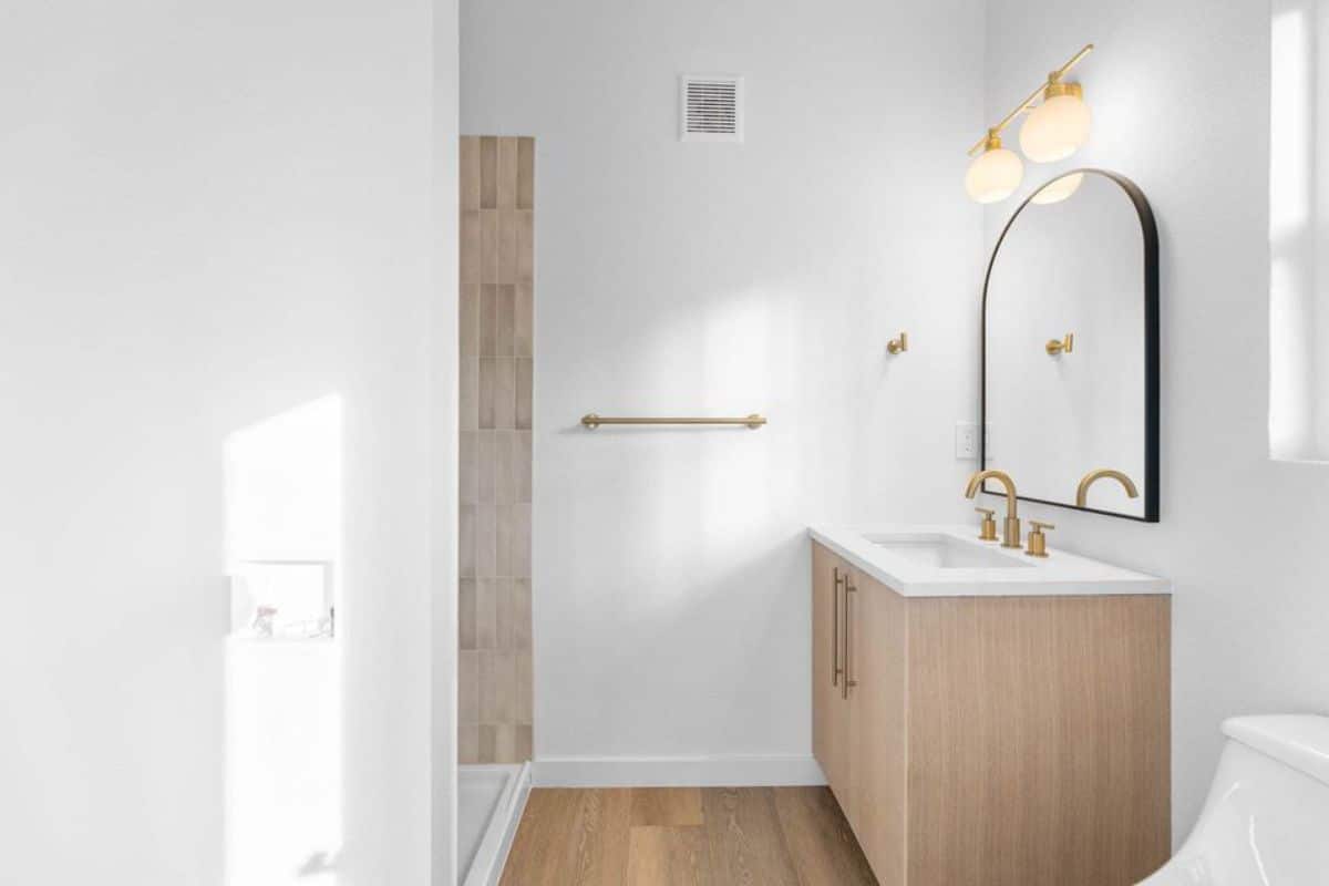 bathroom of contemporary tiny home has all the standard fittings
