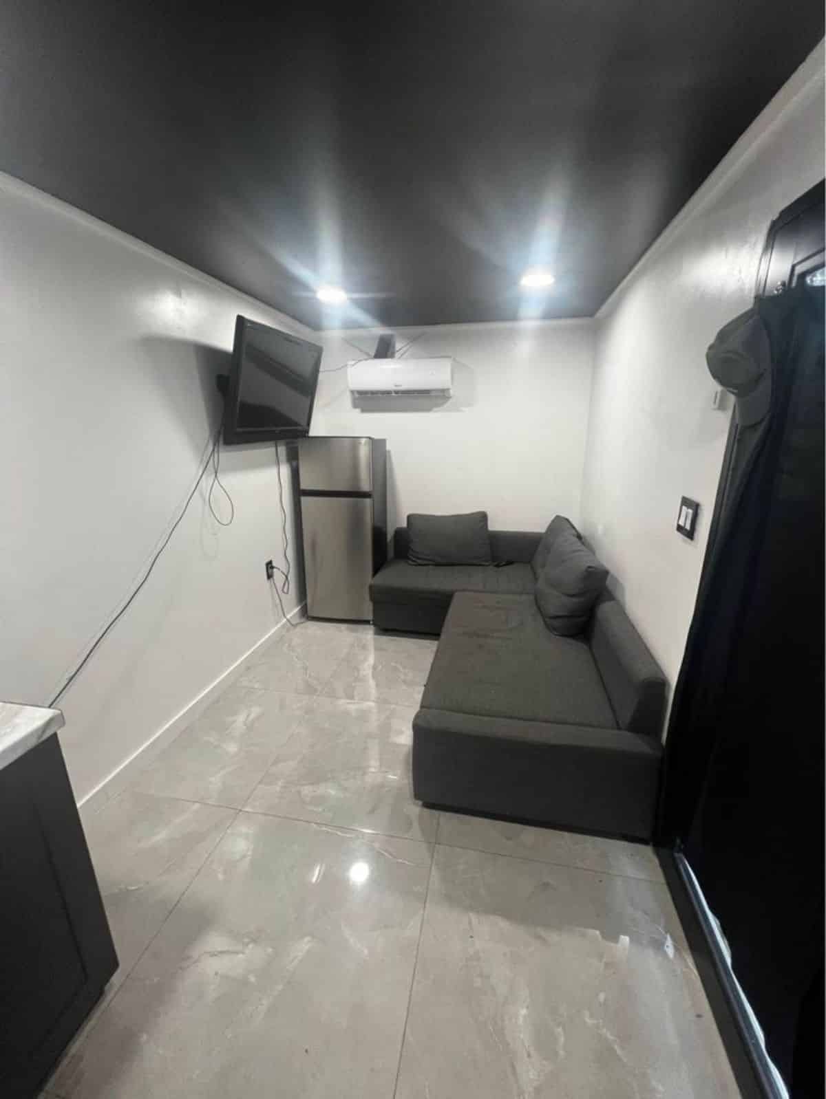 living cum sleeping area of budget tiny home has a convertible couch
