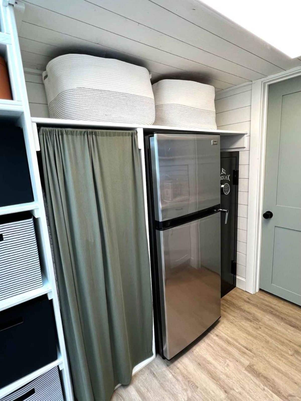 opposite side has a doble door refrigerator and other storage cabinets
