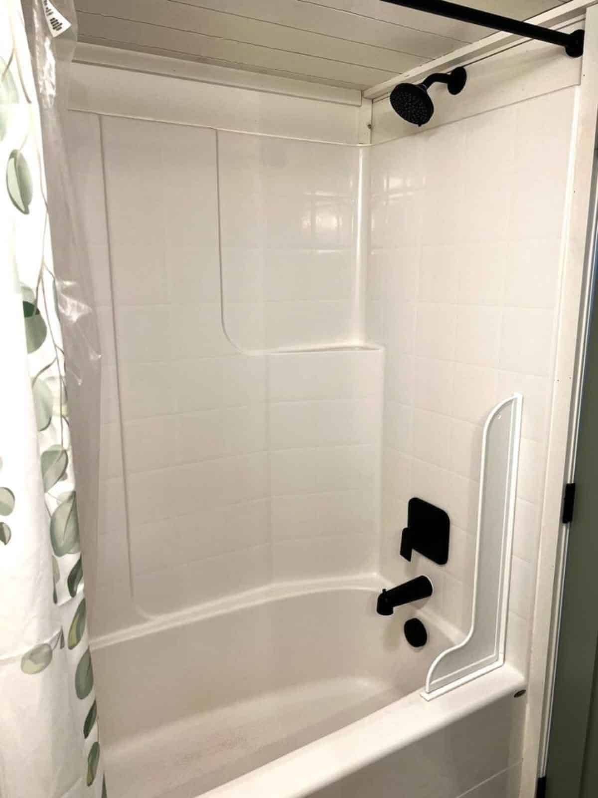 full length shower and bathtub in bathroom