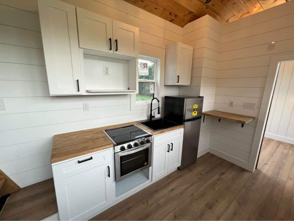 stylish and very well designed kitchen area of 28’ tiny farmhouse