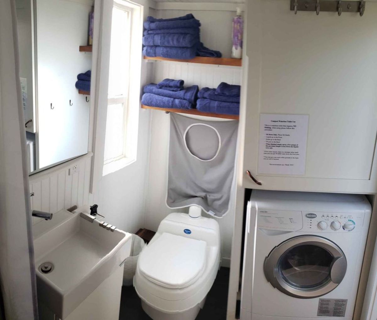 composting toilet and washer dryer combo in bathroom of 28’ upgraded tiny home