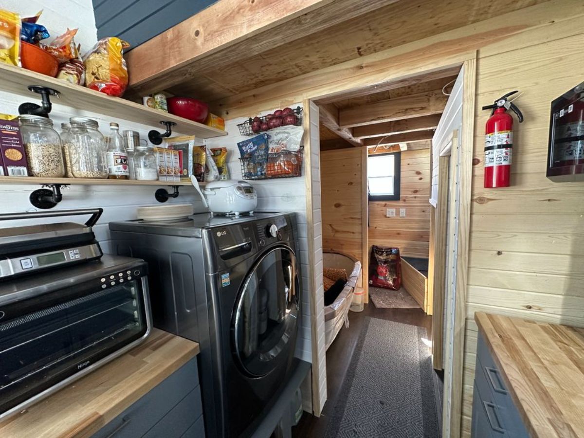 washer dryer combo present in the kitchen area of 32' fully furnished tiny home