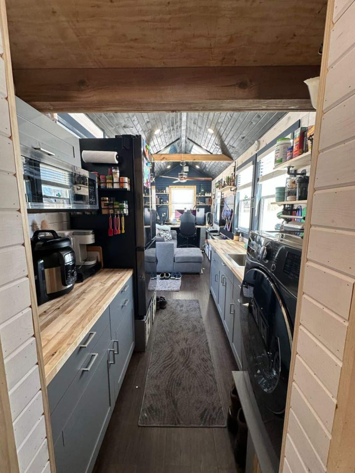 full length interior view of 32' fully furnished tiny home from bathroom view