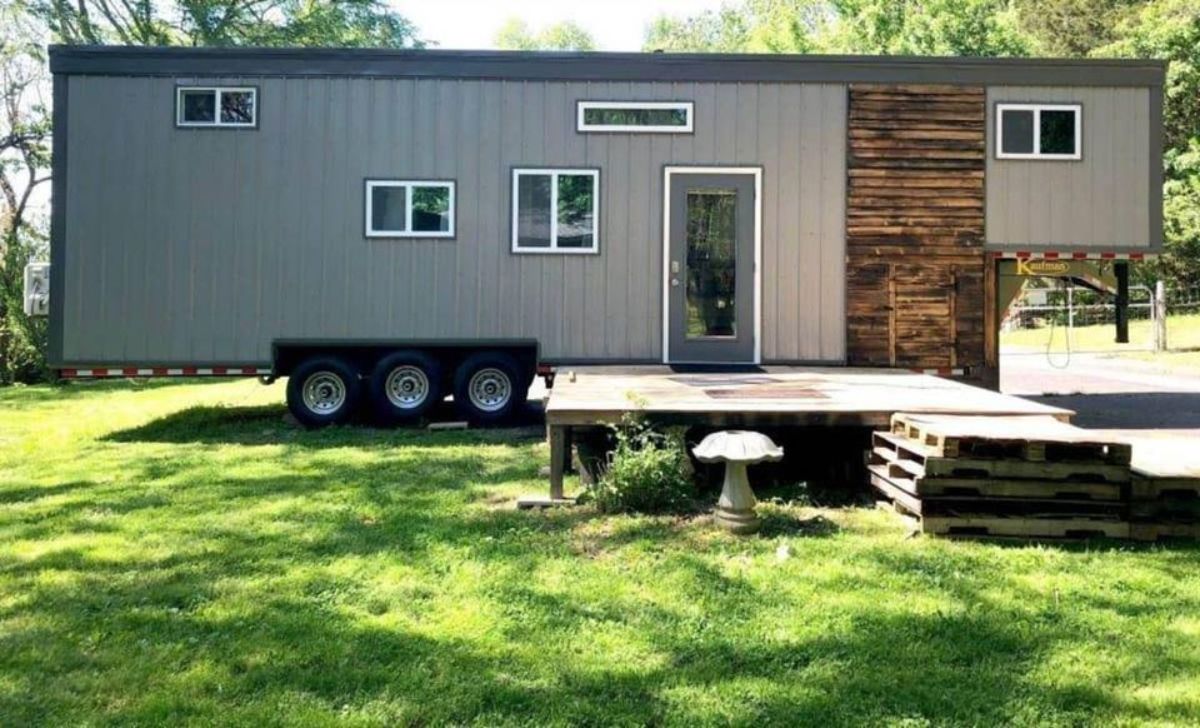 main entrance and stunning exterior of tiny home with two bedrooms