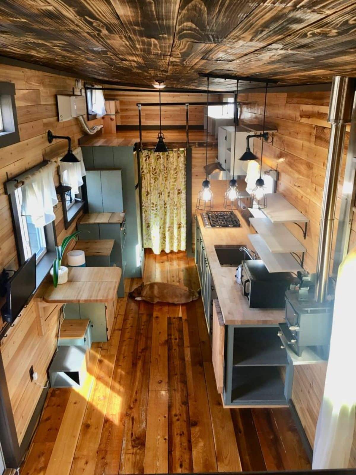huge ceiling and wooden interiors of tiny home with two bedrooms