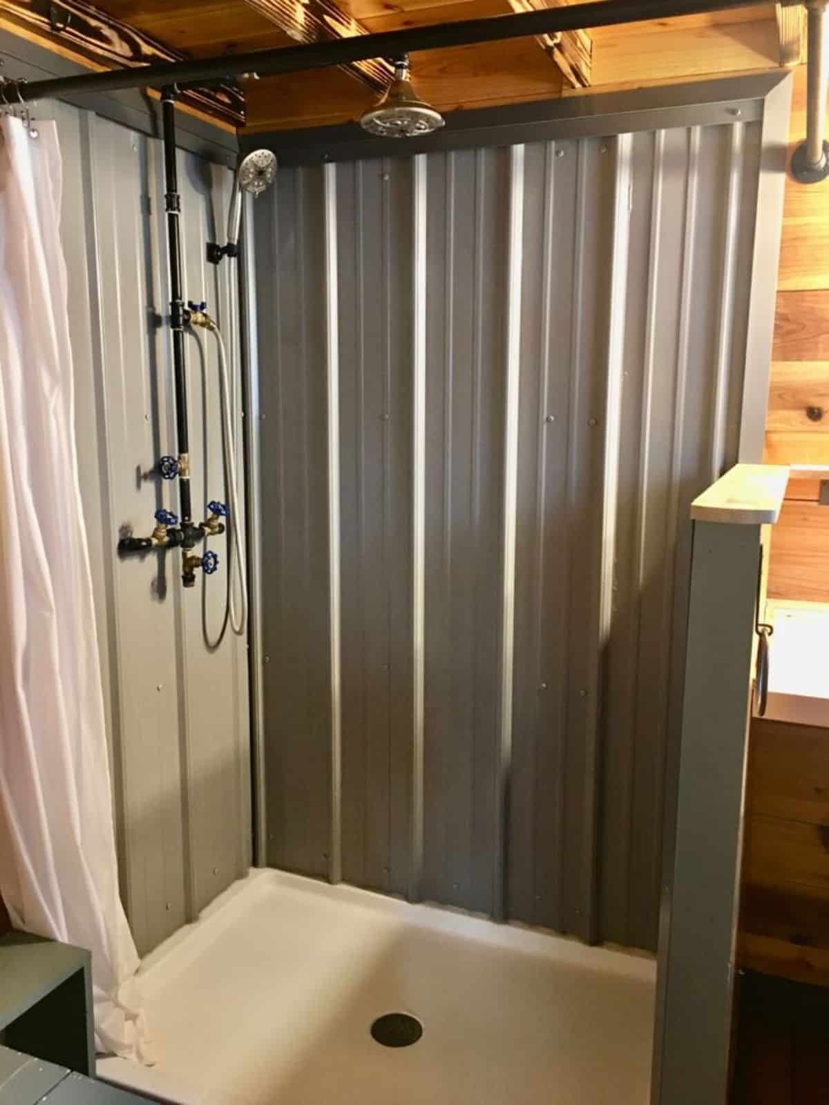 separate shower area with waterfall overhead shower