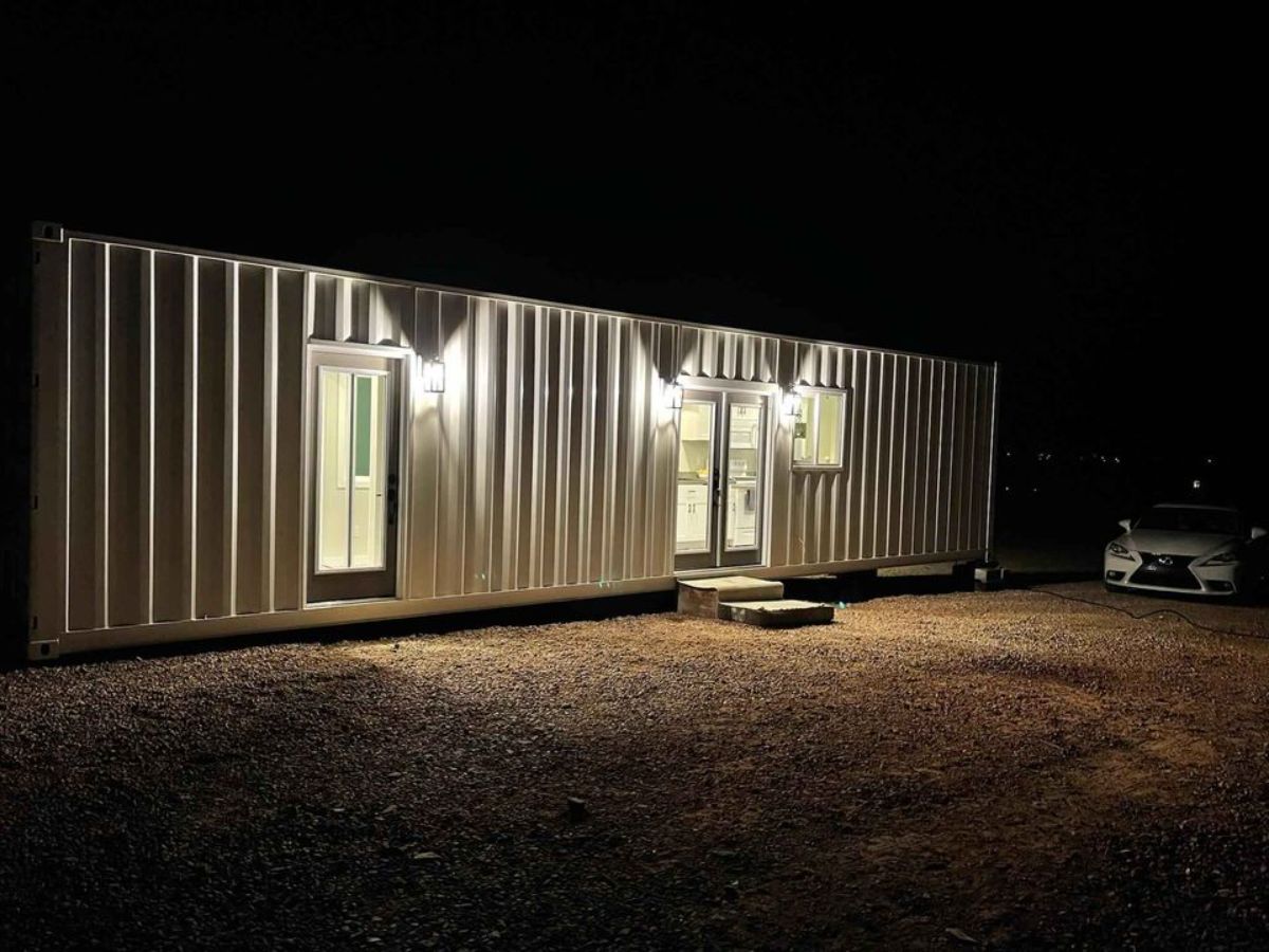 main entrance view of custom container home at night