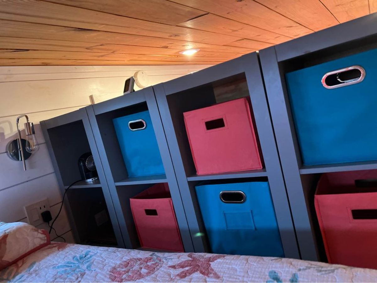 storage cabinets on the loft bedroom of tiny house on wheels