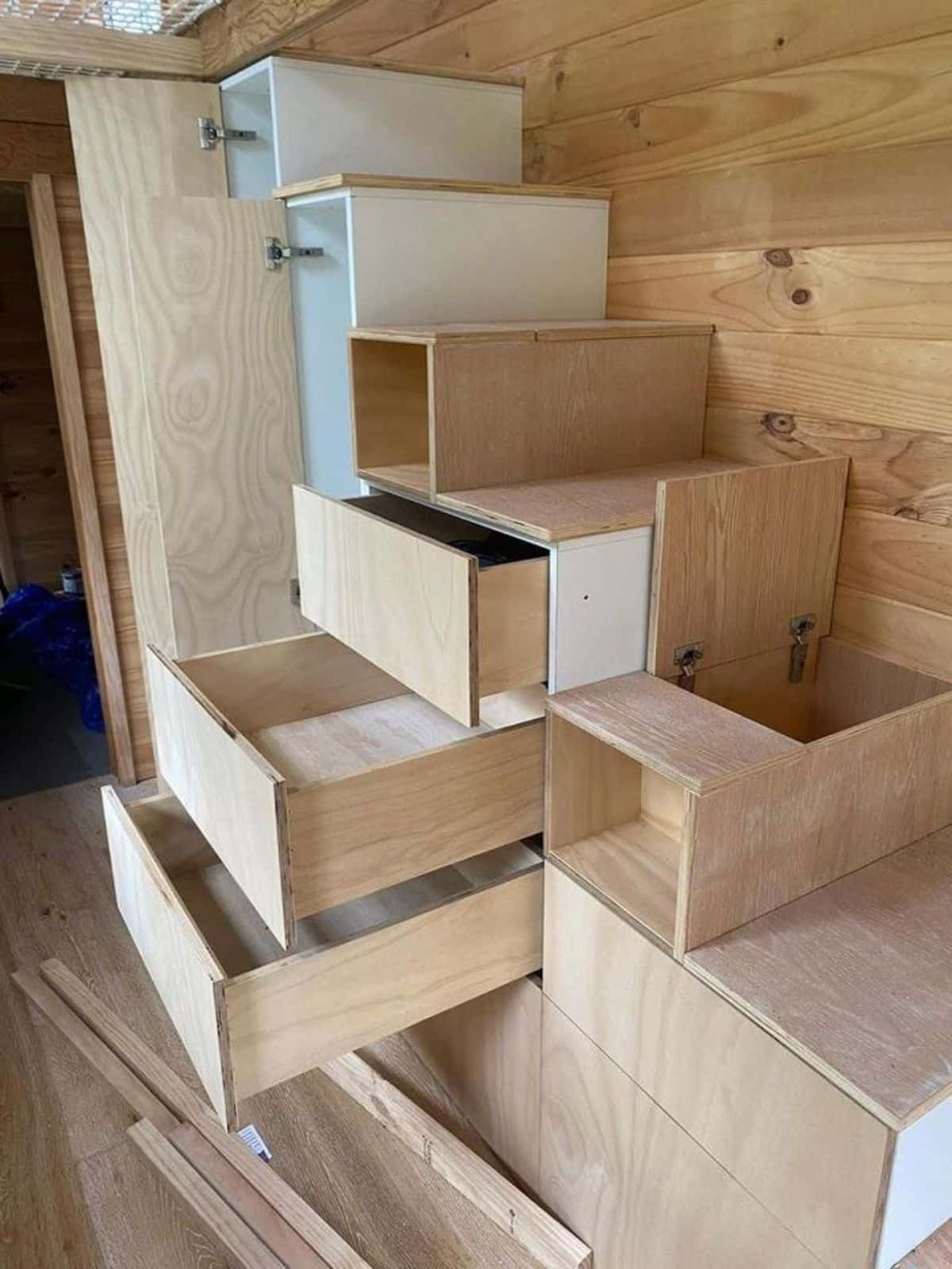 multi purpose stairs with storage cabinets leading to the loft  of Tiny Home In Australia