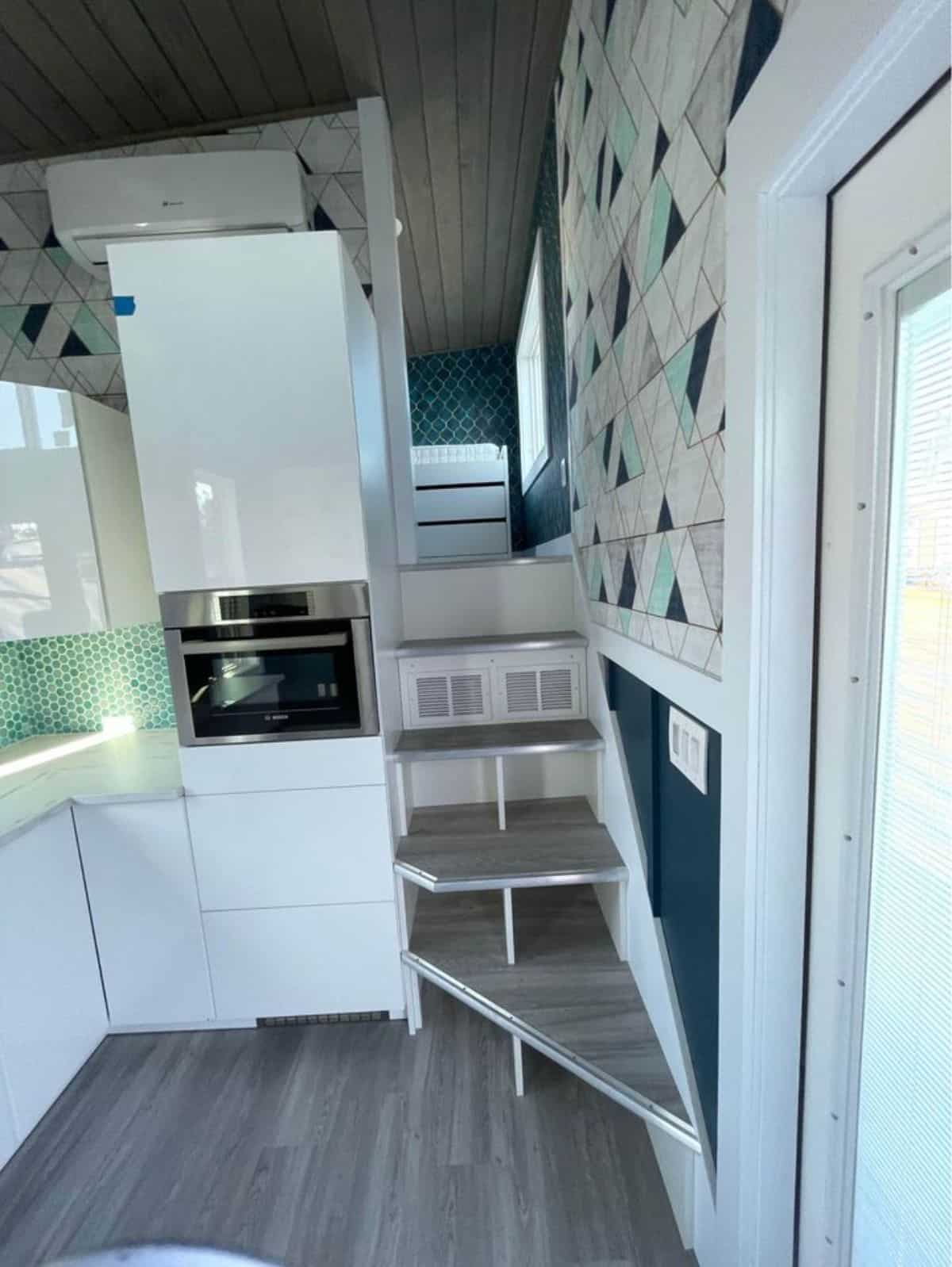 stairs leading to the main bedroom of brand new gooseneck tiny house