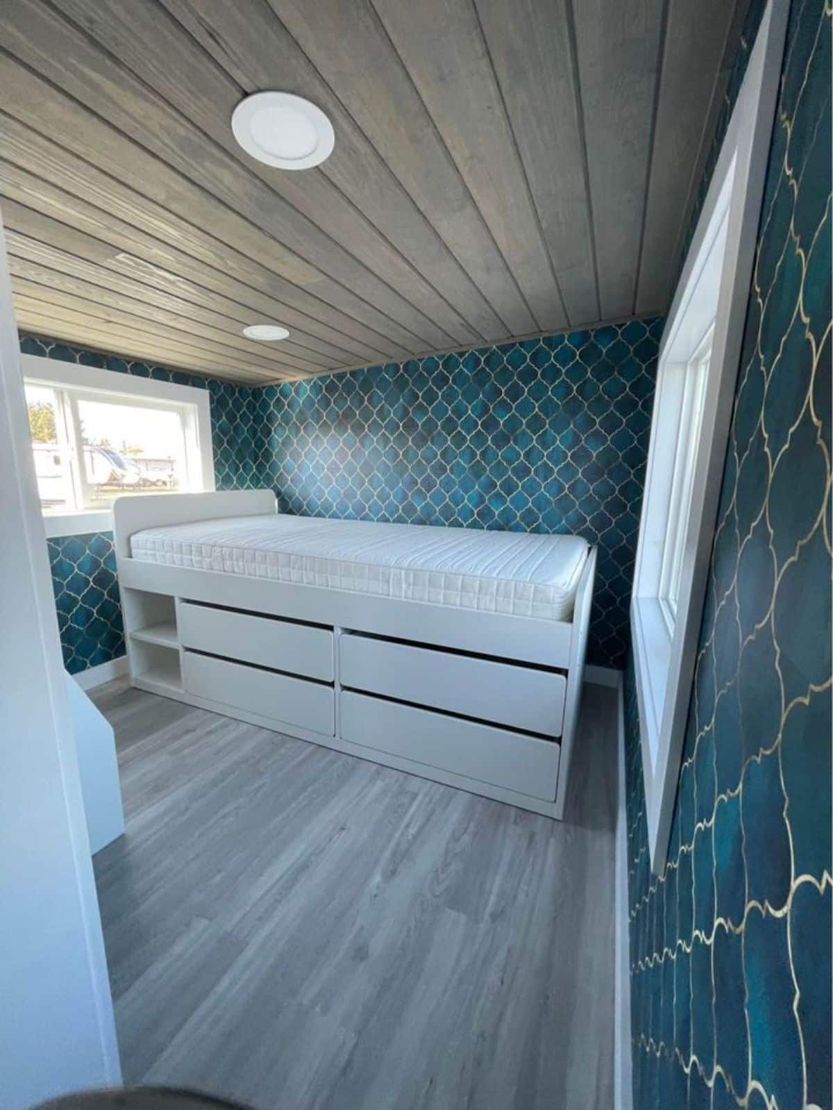 stylish and spacious bed in the bedroom of brand new gooseneck tiny house