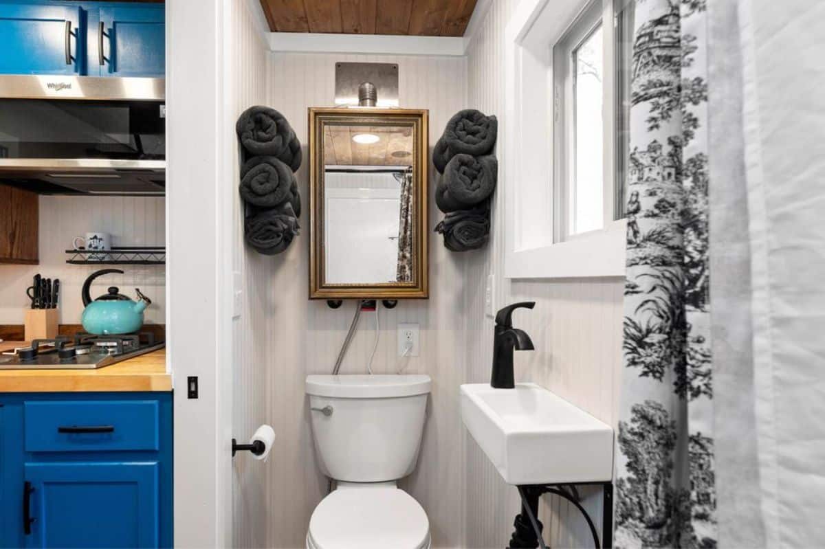 bathroom of custom tiny house on wheels has all the standard fittings