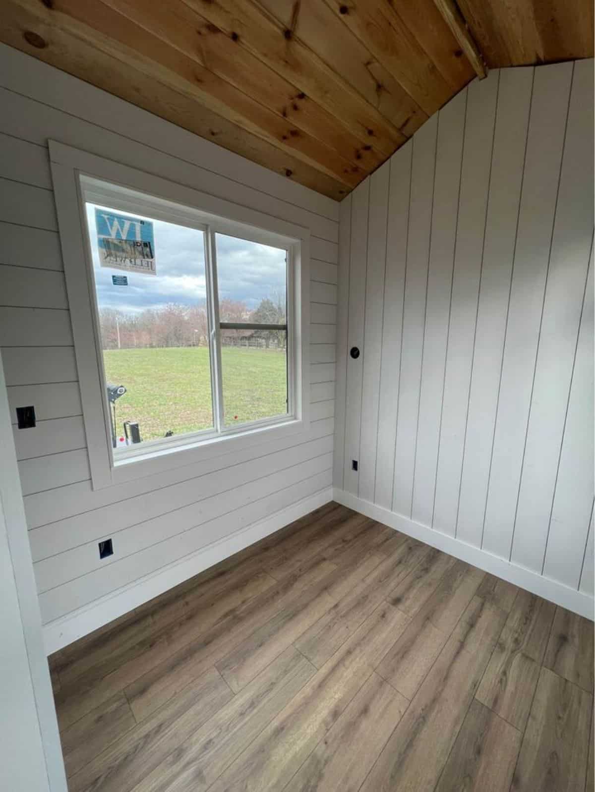 comfortable and cozy bedroom area of farmhouse style tiny home