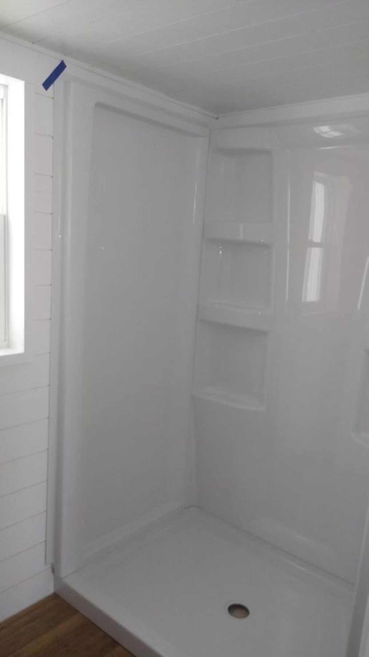 full walk in shower in bathroom of fully furnished tiny home