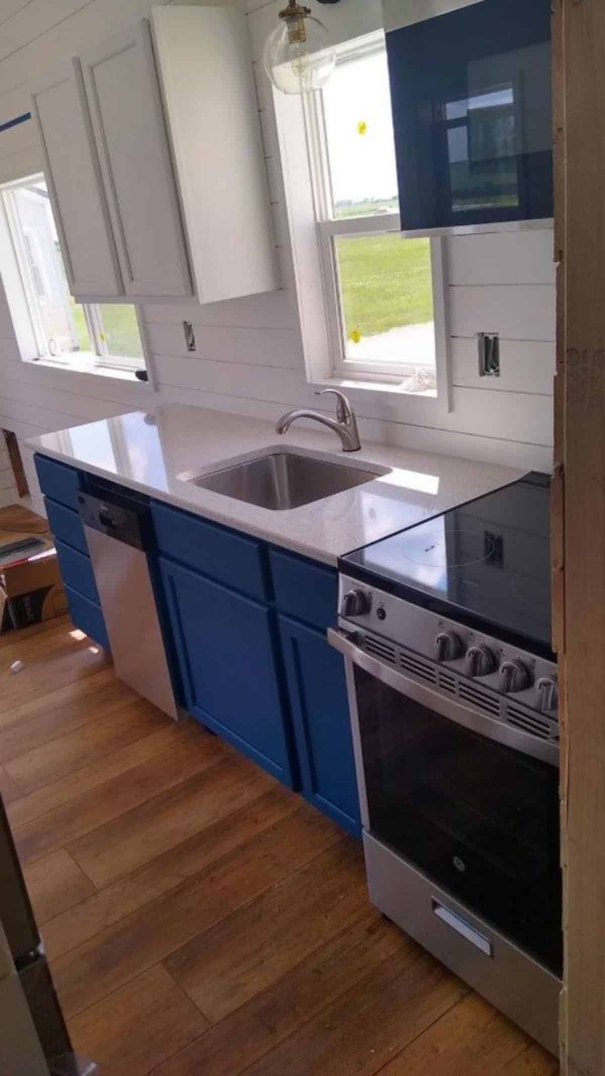 a microwave and 4 burner stove is included in this fully furnished tiny home