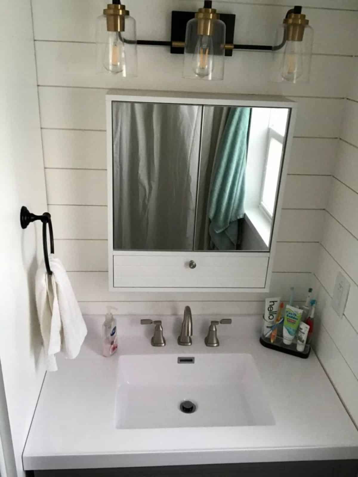 full fledge marble sink with vanity and mirror in bathroom