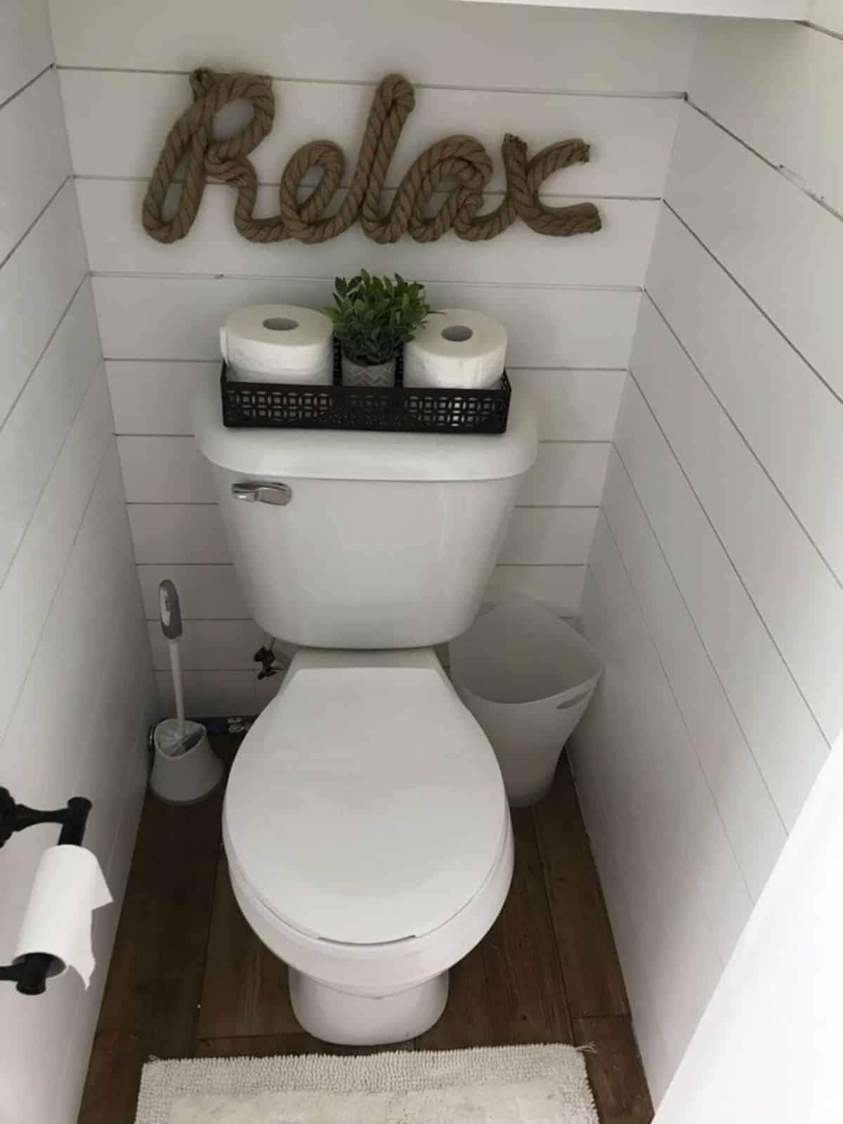 standard toilet to relax in bathroom of fully furnished tiny home