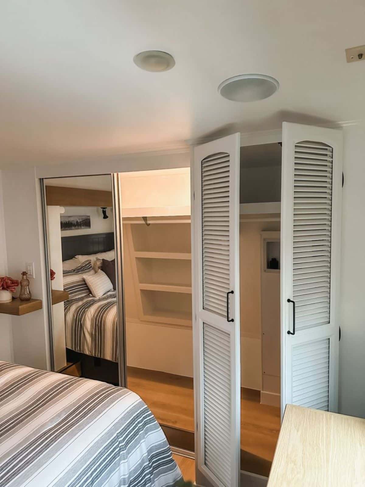 huge double door closet with hook up for washer dryer combo in bedroom