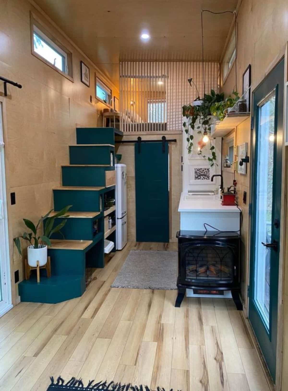 multi purpose stairs leading to the loft bedroom has an oven, a refrigerator underneath