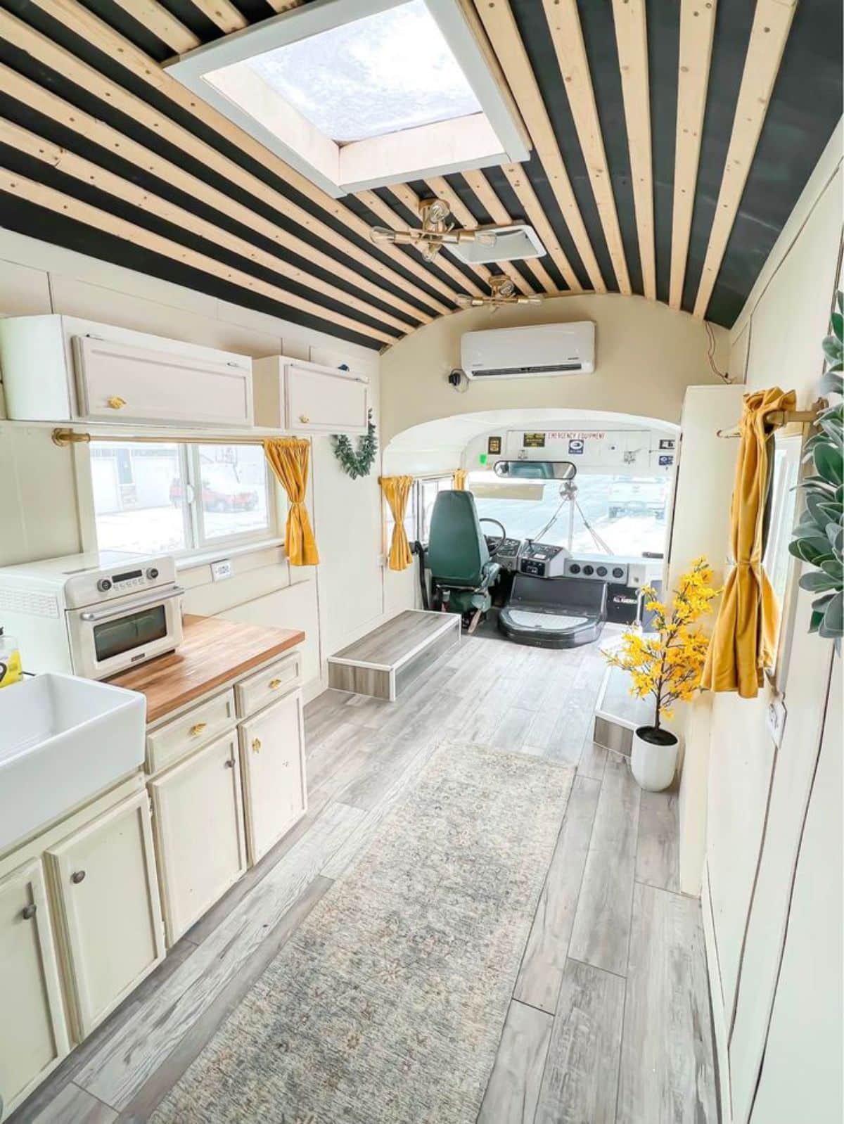 full length interiors with huge open space, air condition unit of Skoolie tiny home