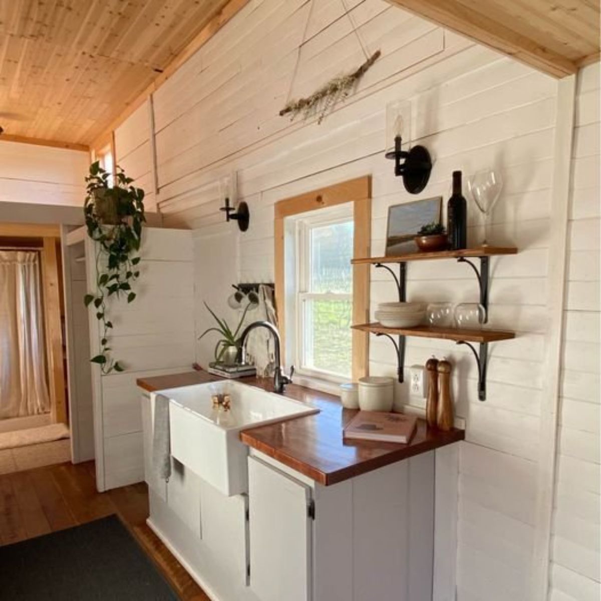 white walls and interiors of spacious 2 bedroom tiny home