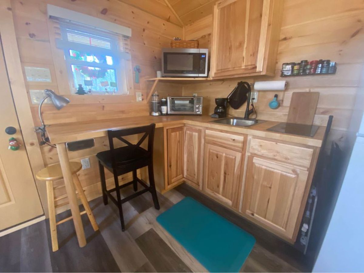 kitchen area has all the appliances of tiny house