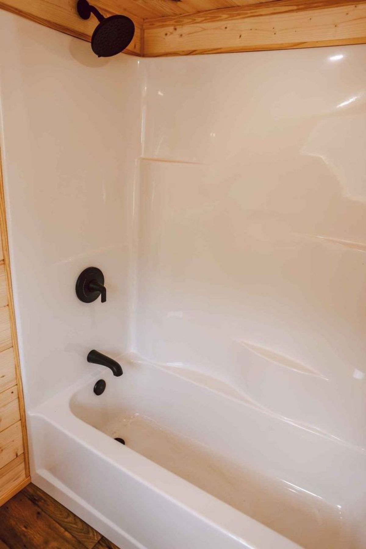 bathtub is included in the bathroom of spacious tiny house on wheels