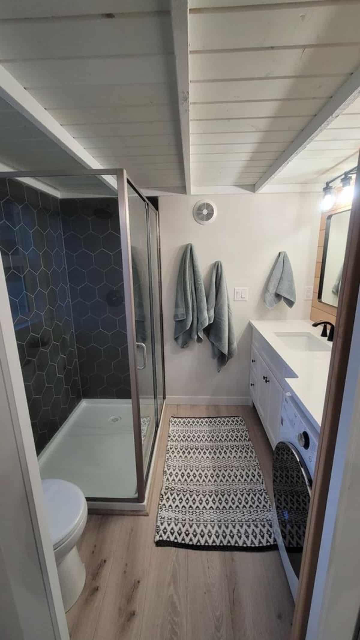 bathroom of custom built tiny home is spacious and its all white styles with standard fittings