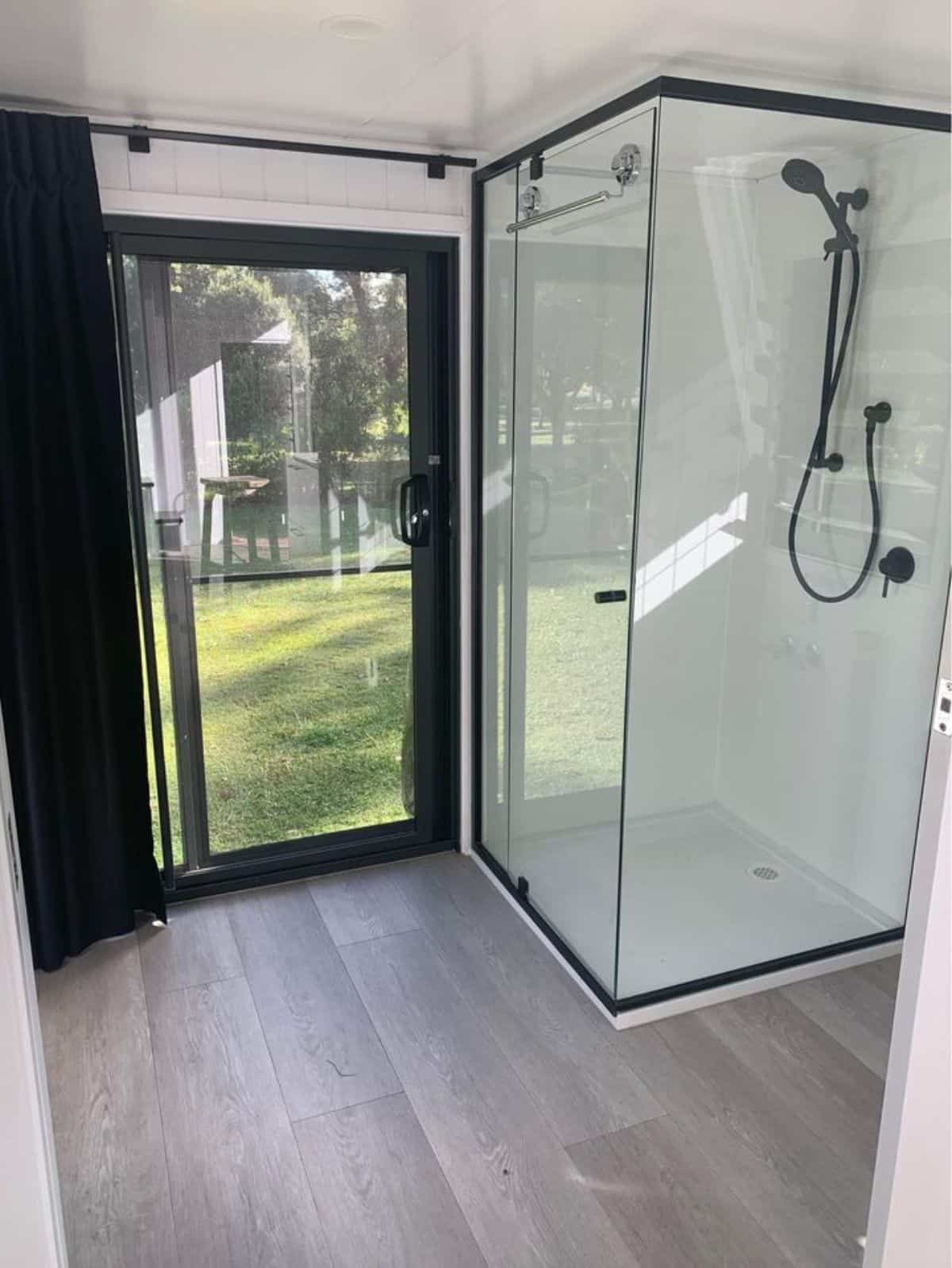 square glass enclosure shower area in bathroom and ample space to walk around
