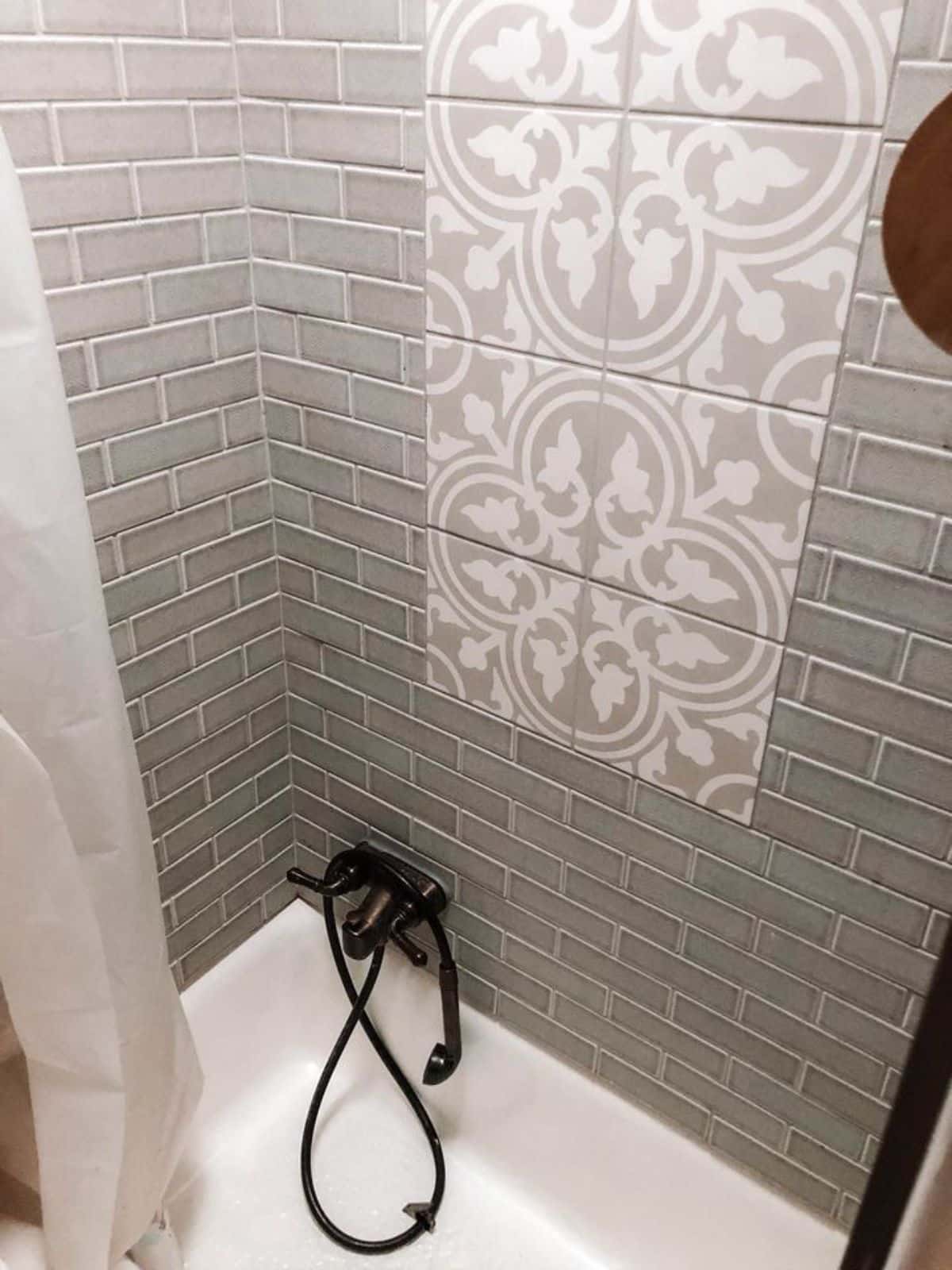 full length tiled shower area  in bathroom of tiny trailer house