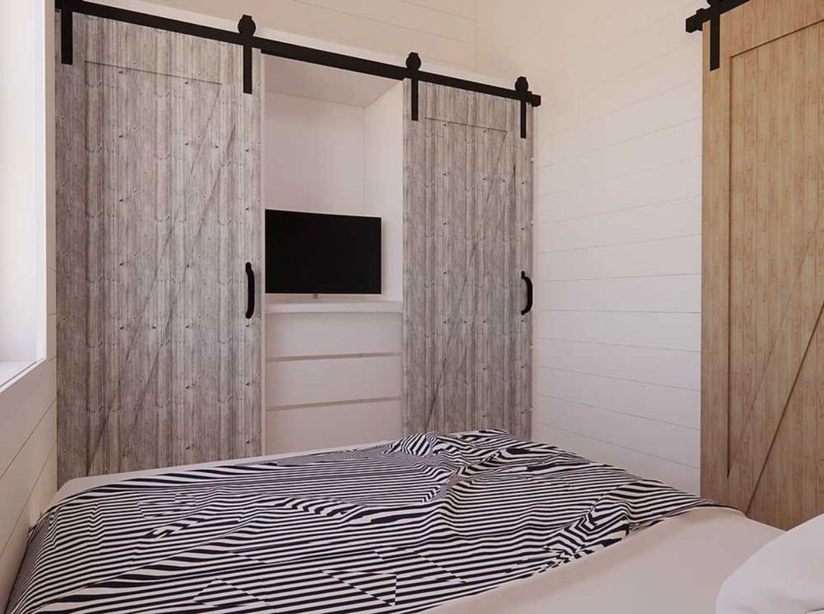 2 bedrooms of two bed tiny home are super spacious with comfortable bed and wardrobe with TV