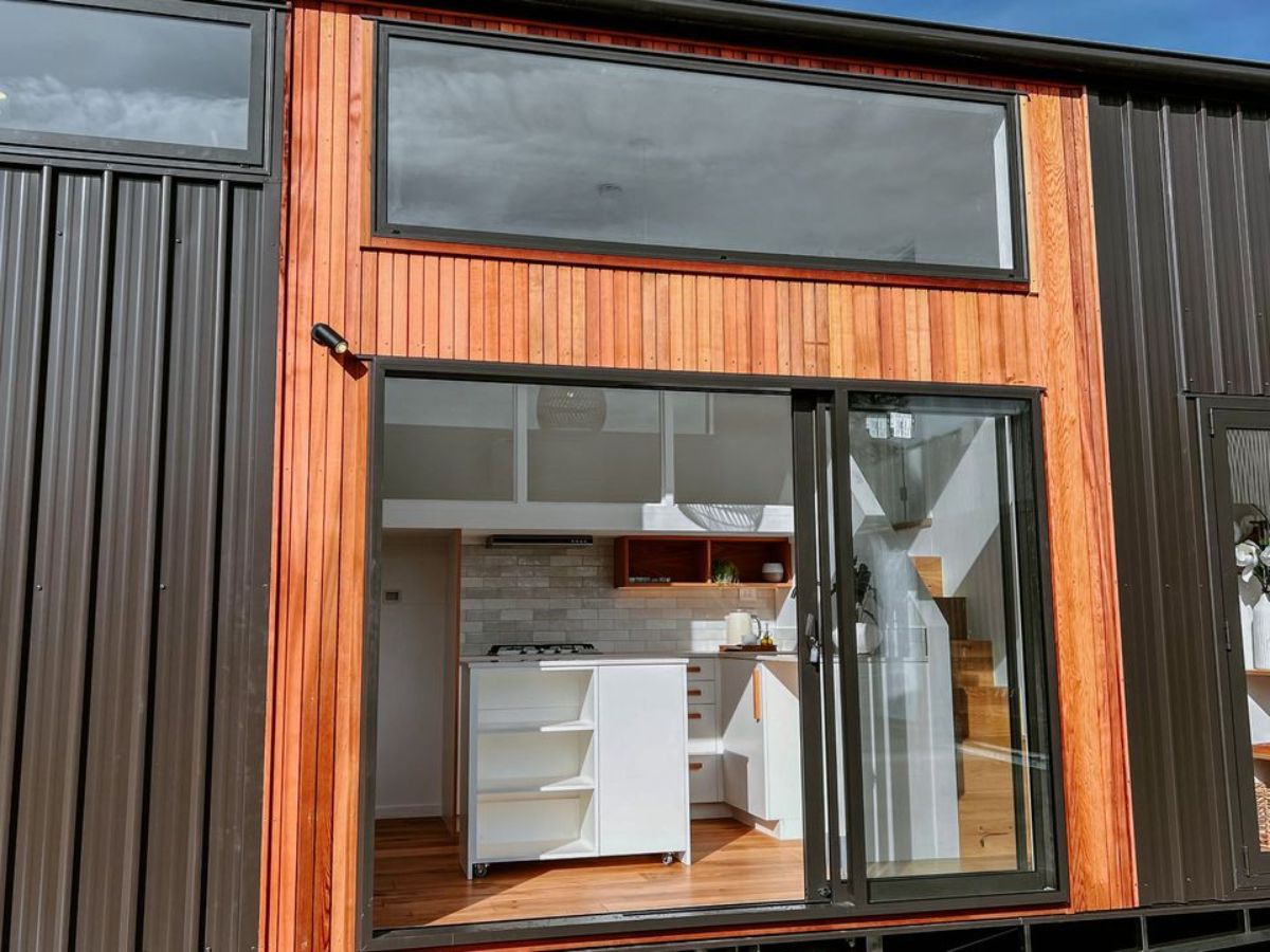 main entrance and stunning black and brown exterior of 2 bedroom tiny house