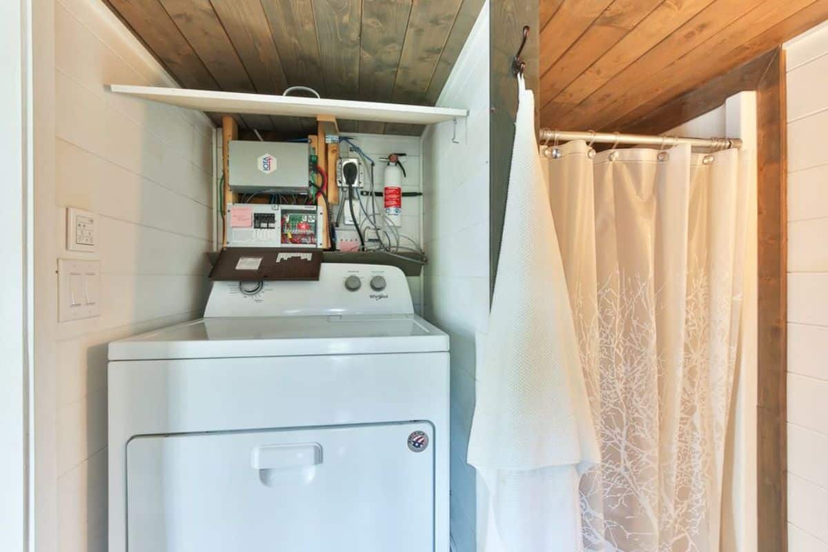 washer dryer combo included in the bathroom of tiny offgrid home
