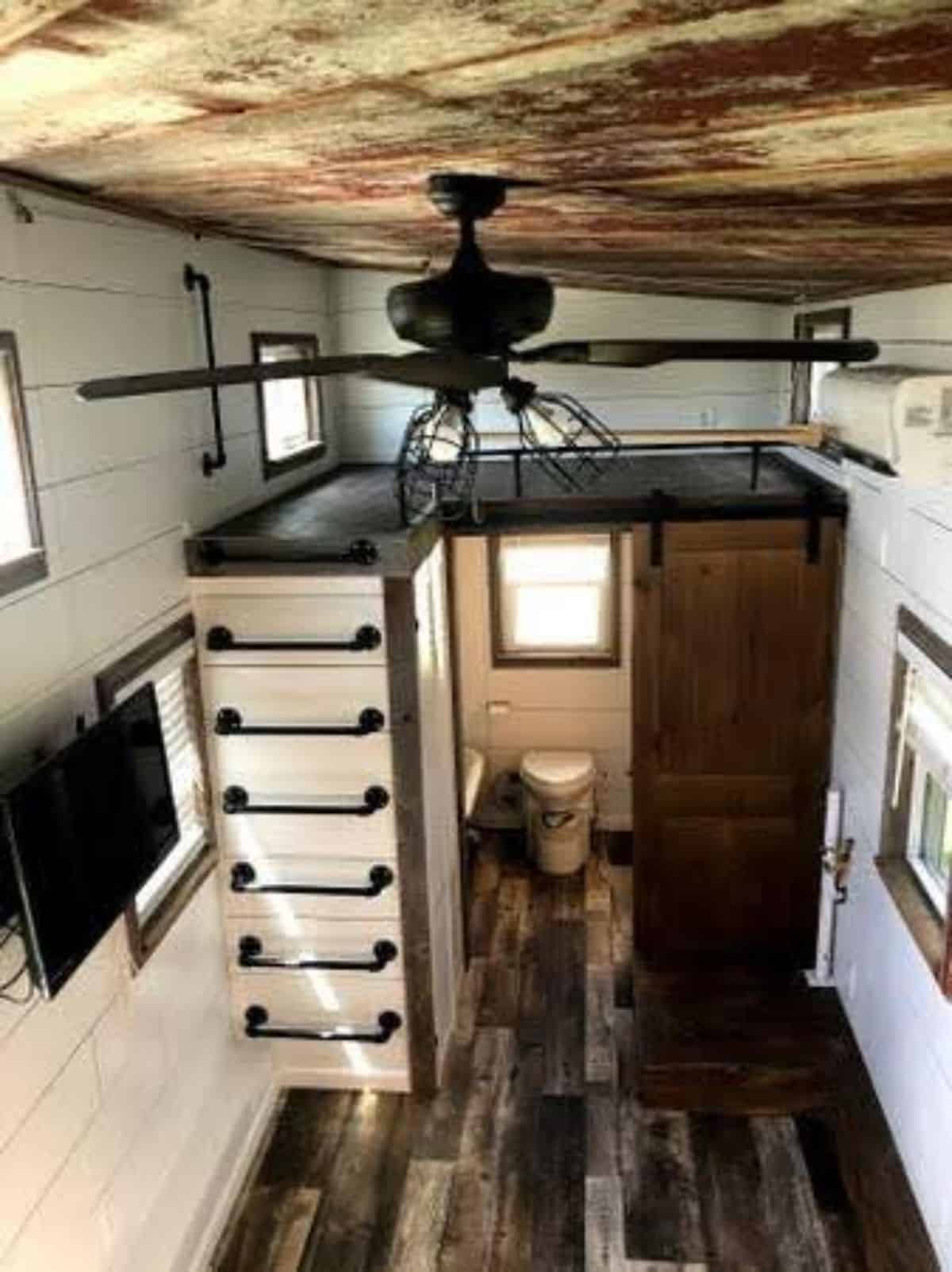 huge ceiling and antique fan in living area of 24' fully furnished tiny home