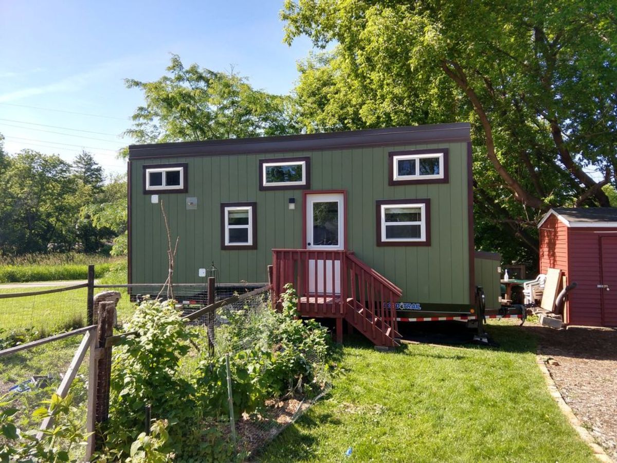 green exterior walls of 24' fully furnished tiny home