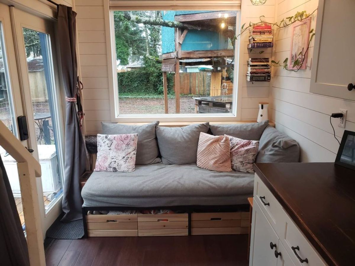 living area of 24’ tiny home has a stunning couch