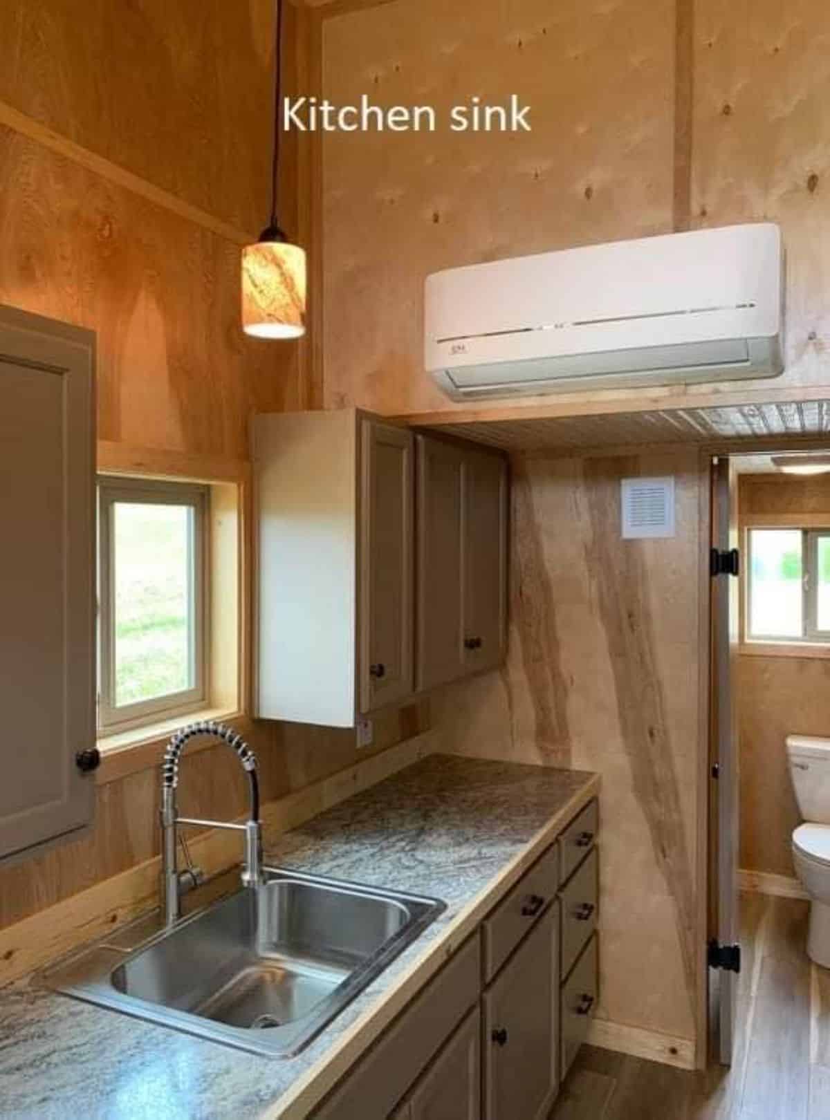 split air condition unit installed above the kitchen countertop of handcrafted tiny home