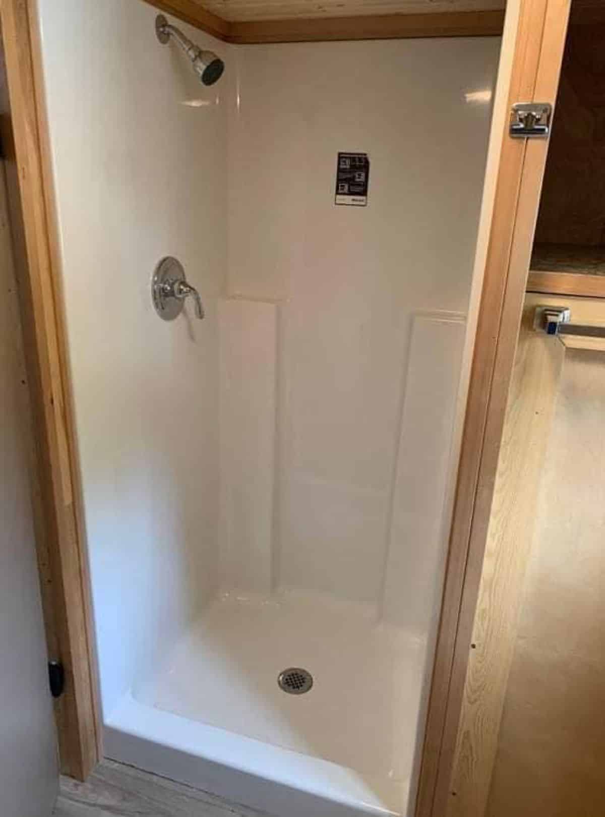 full length shower area in kitchen of handcrafted tiny home