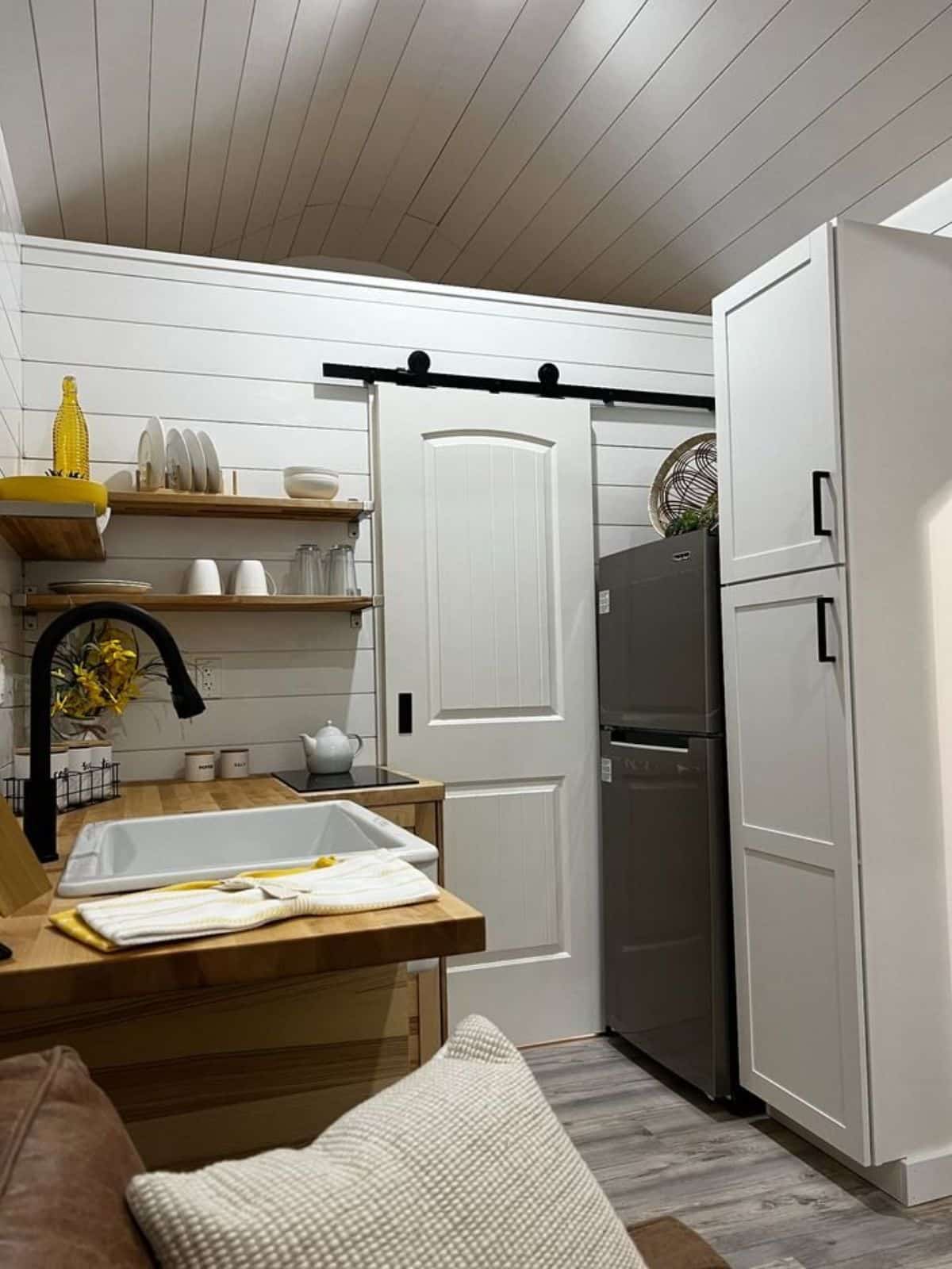 double door refrigerator and full length pantry in the kitchen area