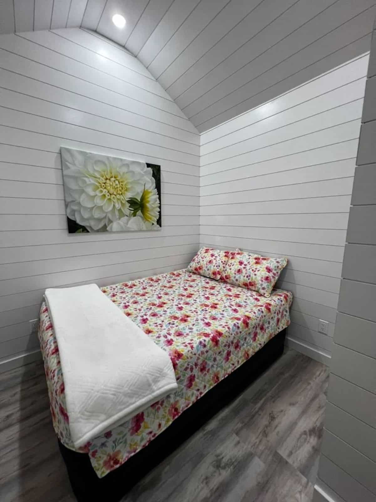 queen bed in bedroom of 26’ tiny home