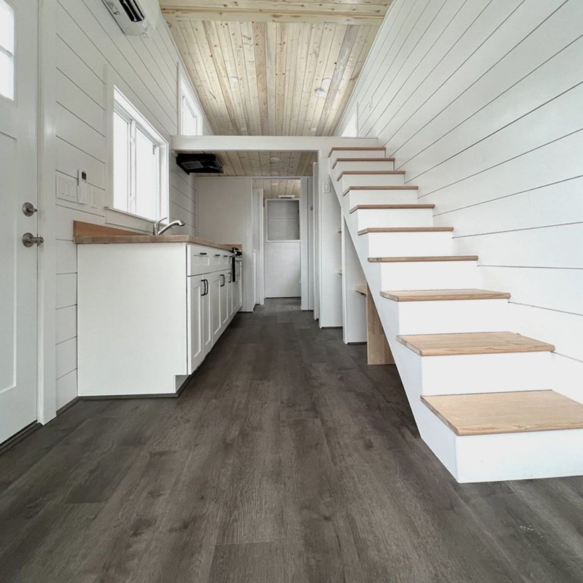 full length white interior with loft view of versatile mobile home