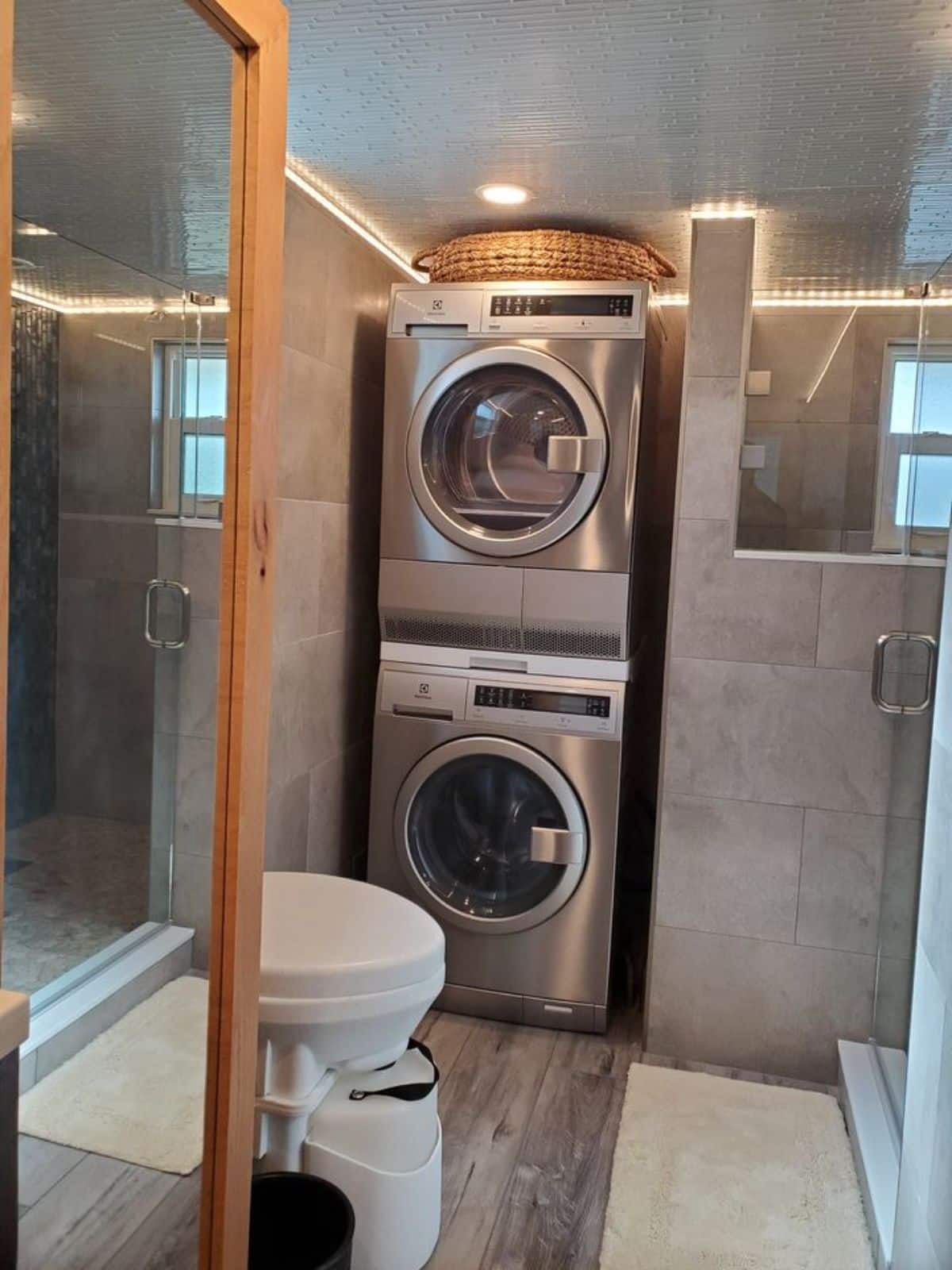 washer dryer combo in bathroom of 30’ luxury tiny house on wheels