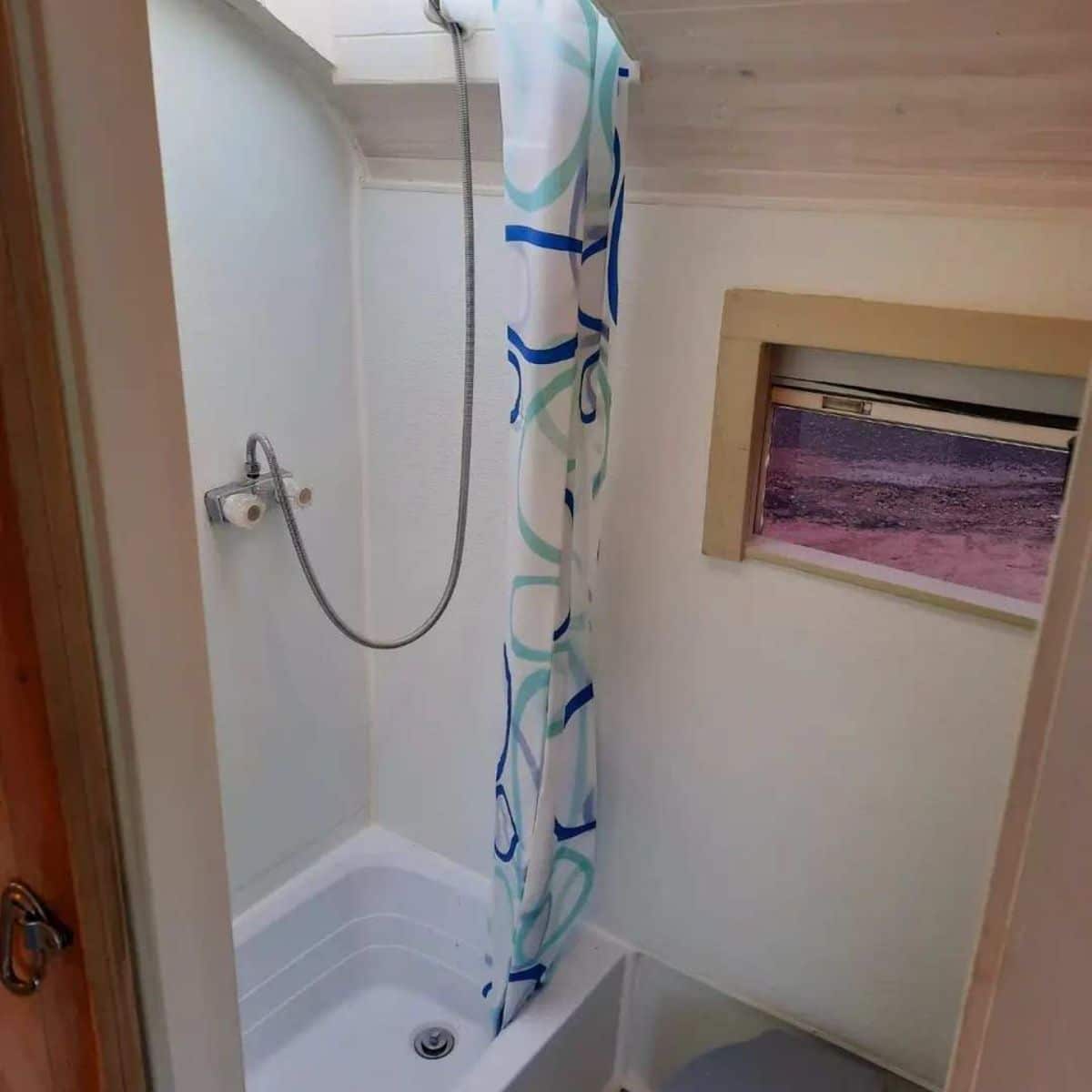 full length shower area in bathroom of 31' budget offgrid home