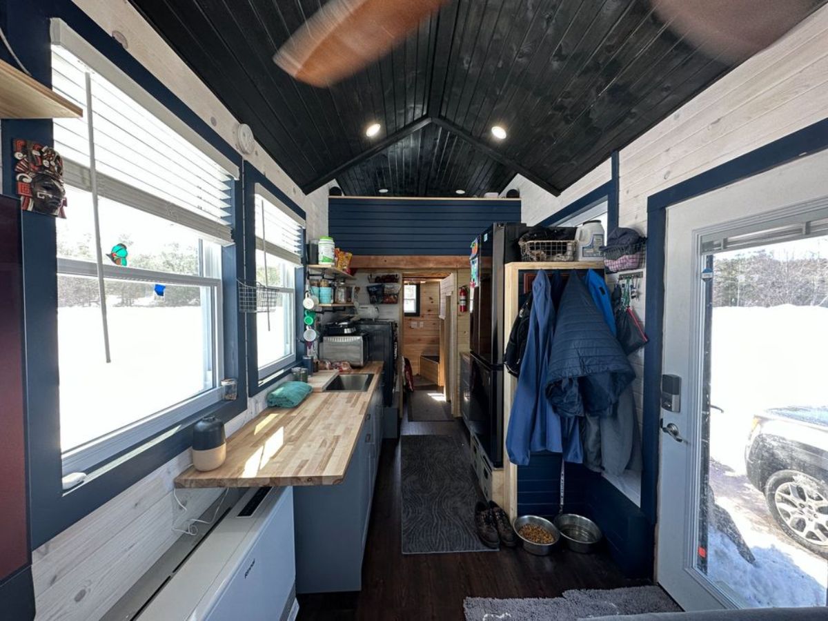 full length interior view of 32' fully furnished tiny home from living room view