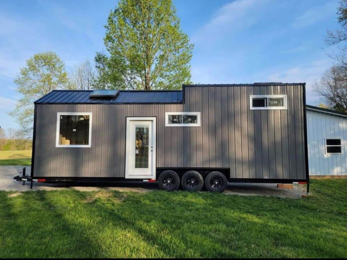 main entrance and stunning exterior view of 32' fully furnished tiny home