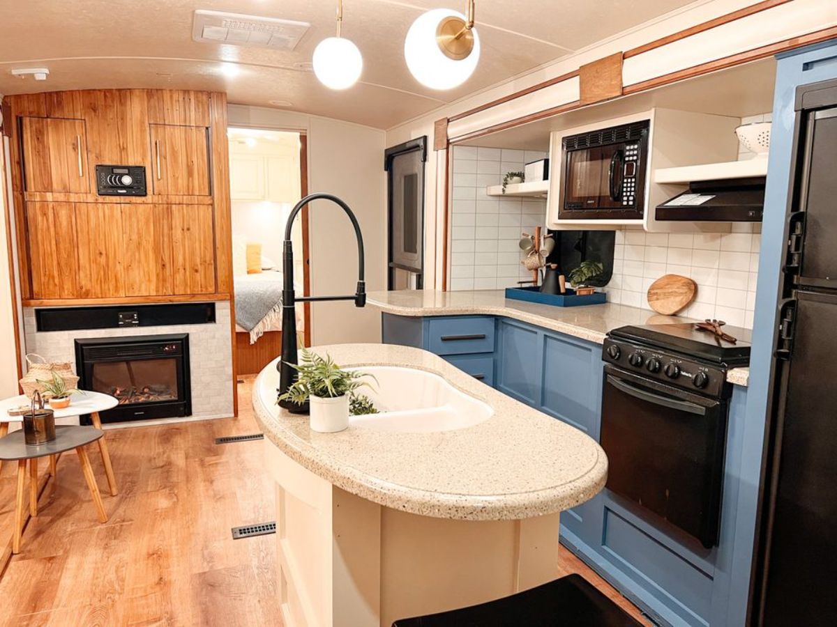 sink and countertop between kitchen and living area of redesigned tiny home