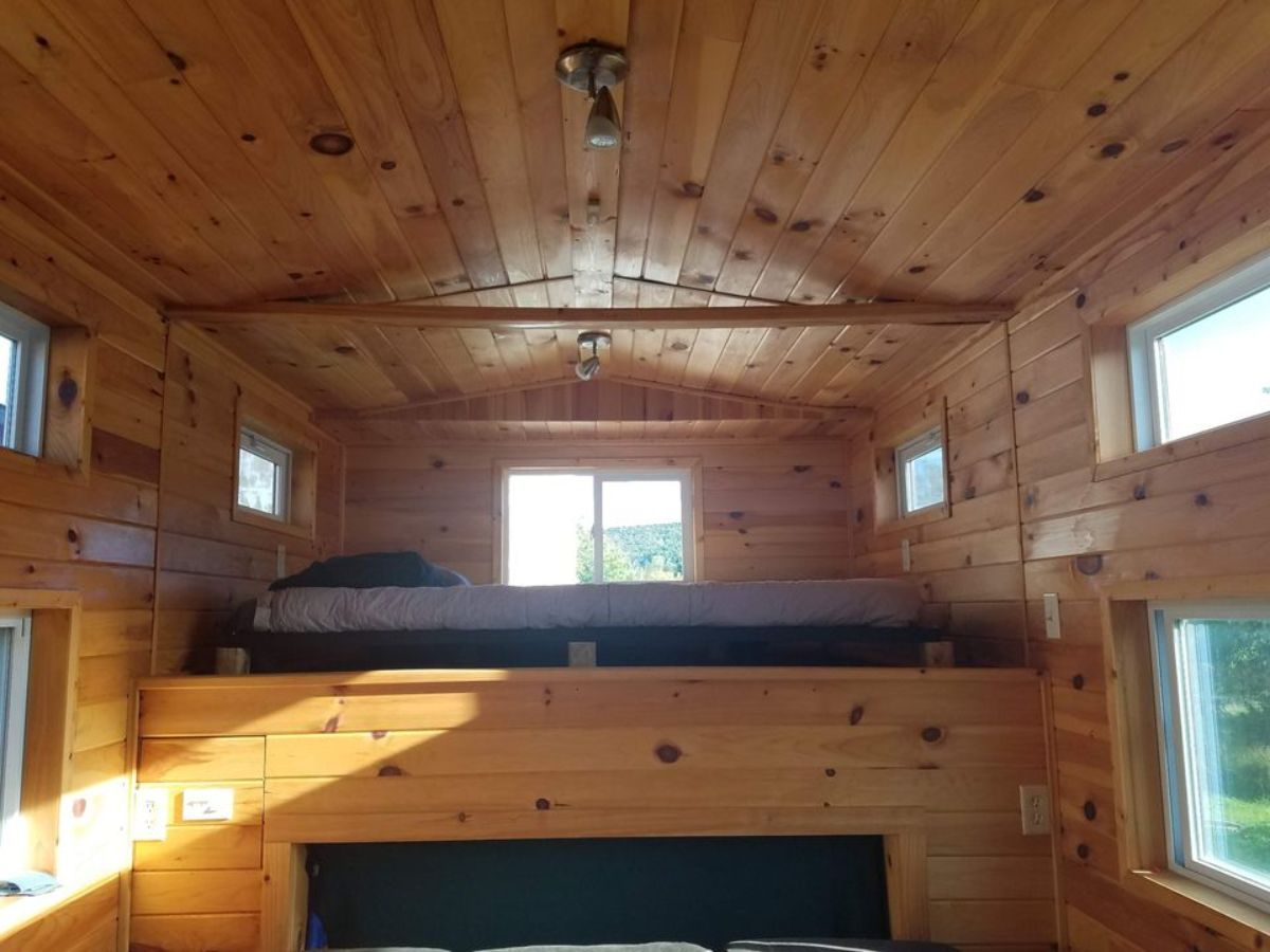 an additional loft above the living rea of rustic motorhome